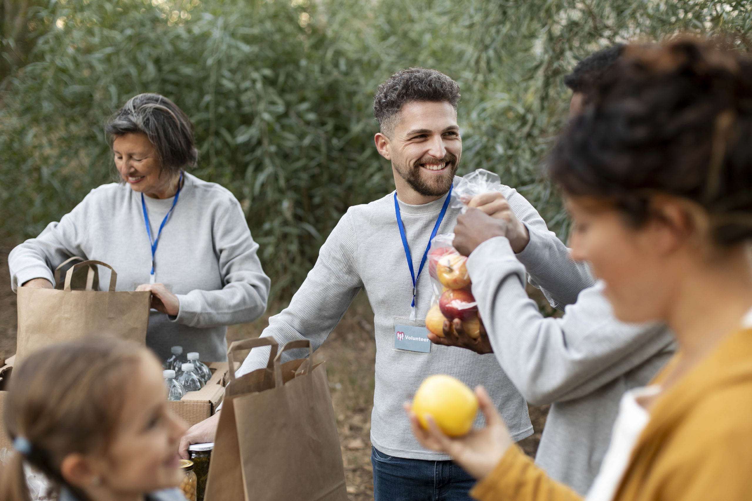 close-up-happy-volunteers-with-food